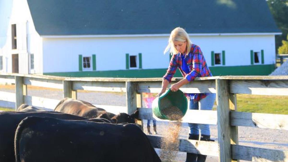 Mary Miller feeding livestock
