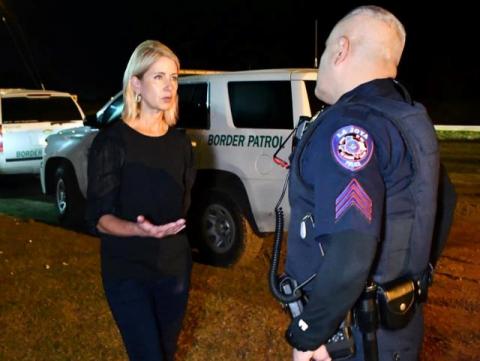 Mary Miller talking to a border patrol agent